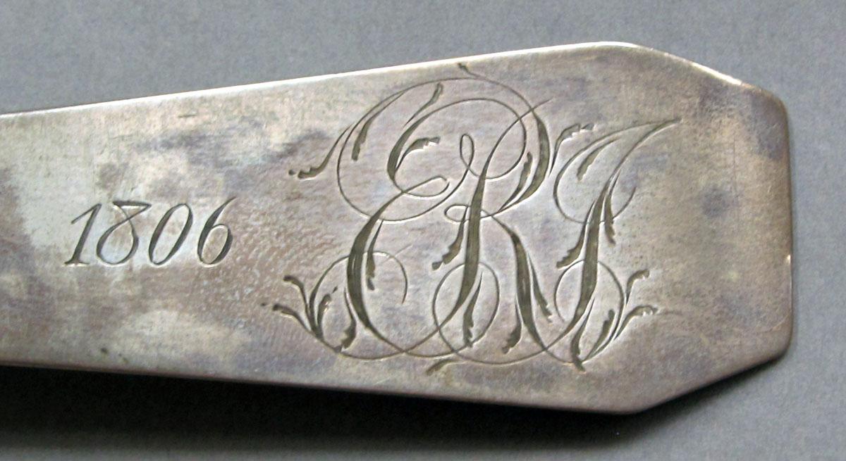 1962.0240.1092 Silver spoon engraving