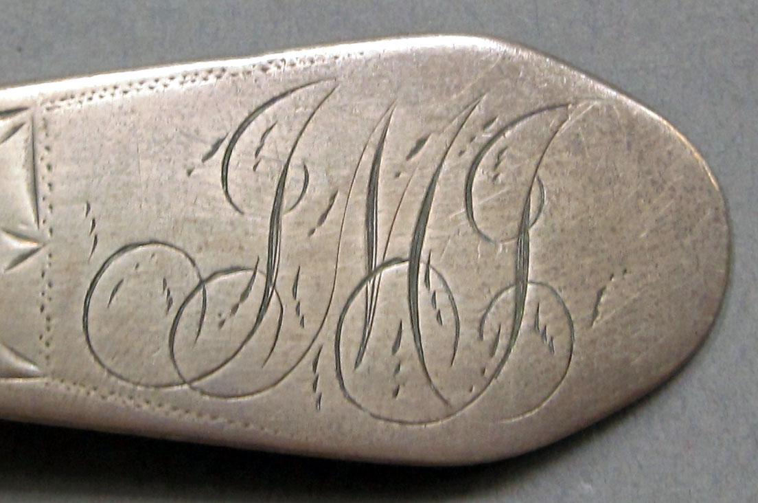 1962.0240.1103 Silver spoon engraving