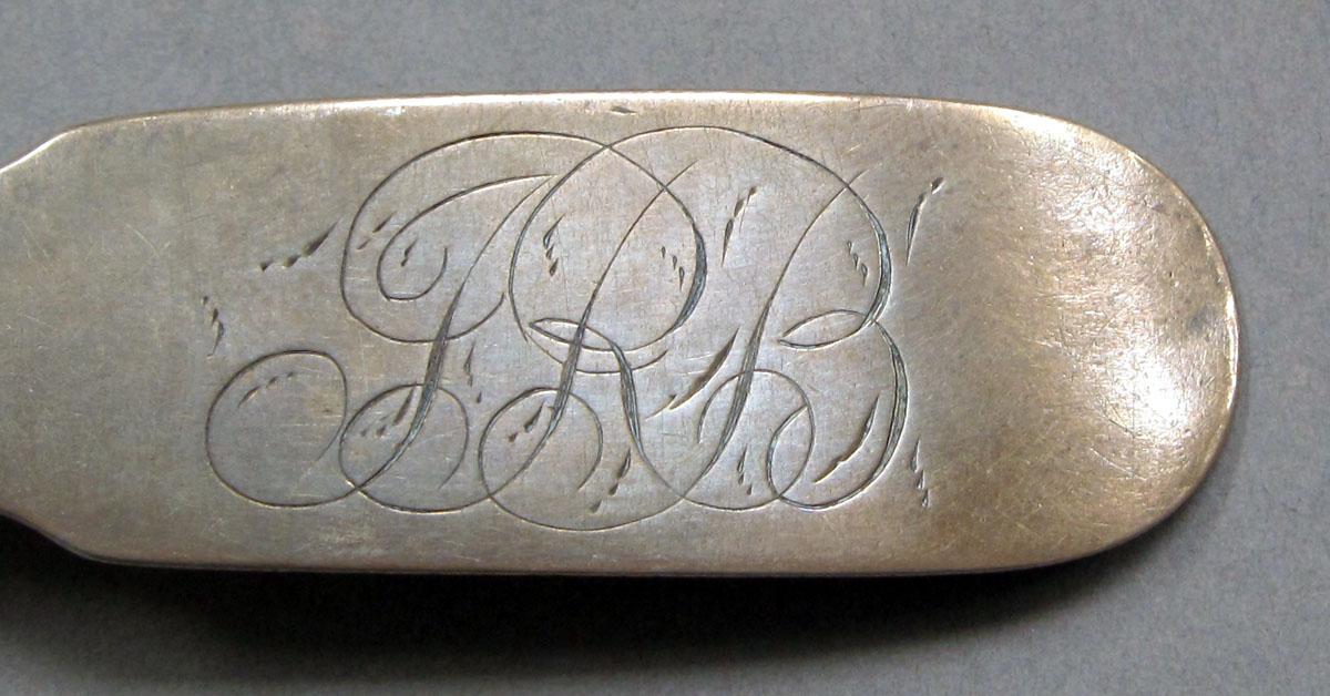 1962.0240.1111 Silver spoon engraving