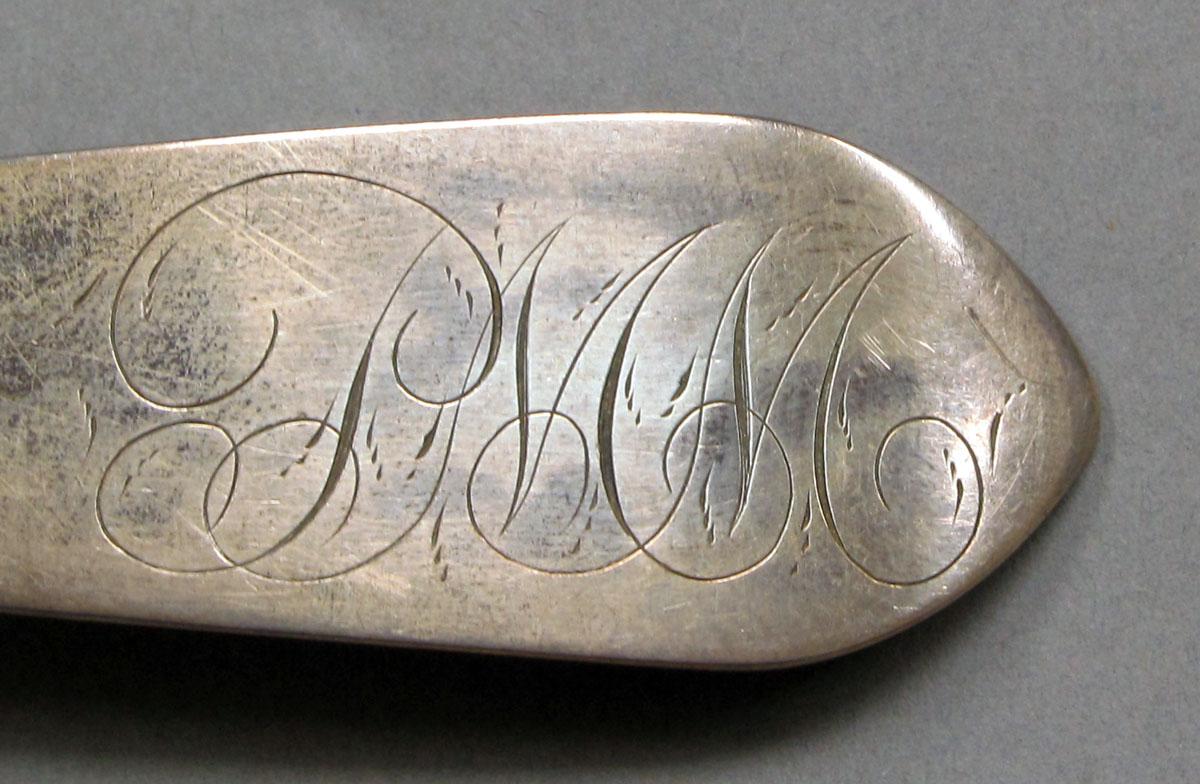 1962.0240.1119 Silver spoon engraving