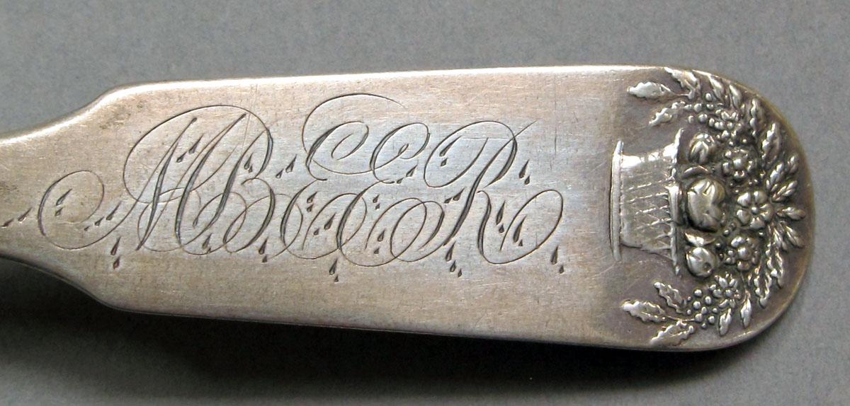 1962.0240.1123 Silver spoon engraving