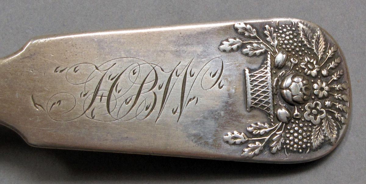 1962.0240.1125 Silver spoon engraving