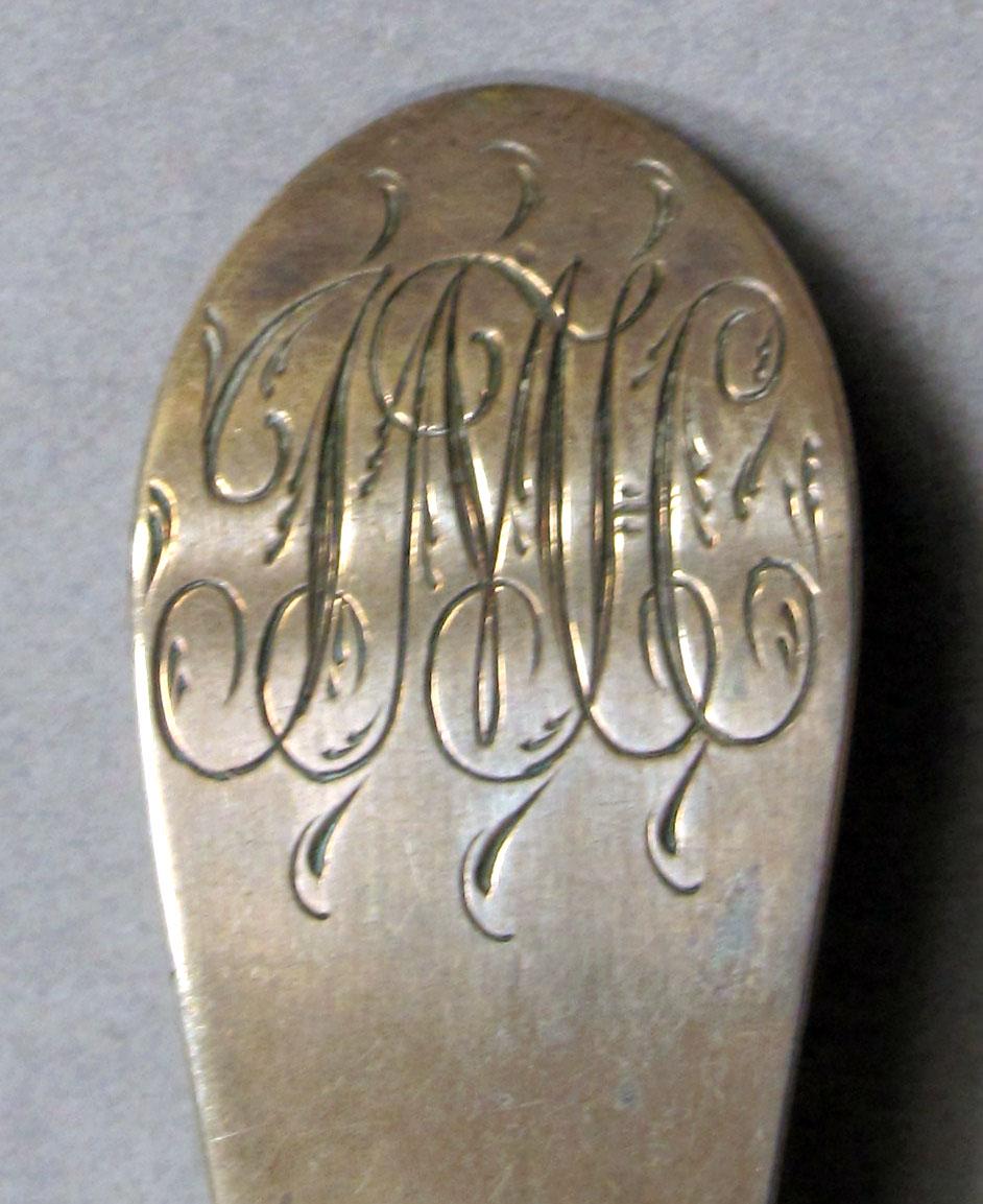1962.0240.1128 Silver spoon engraving