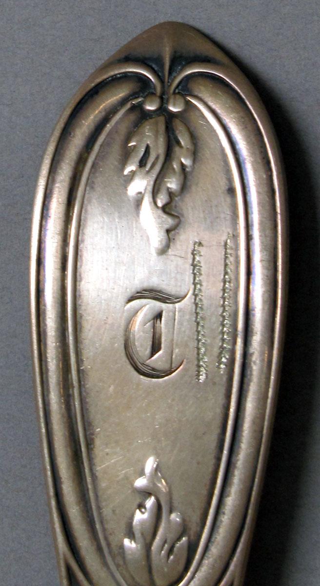 1962.0240.1187 Silver spoon engraving