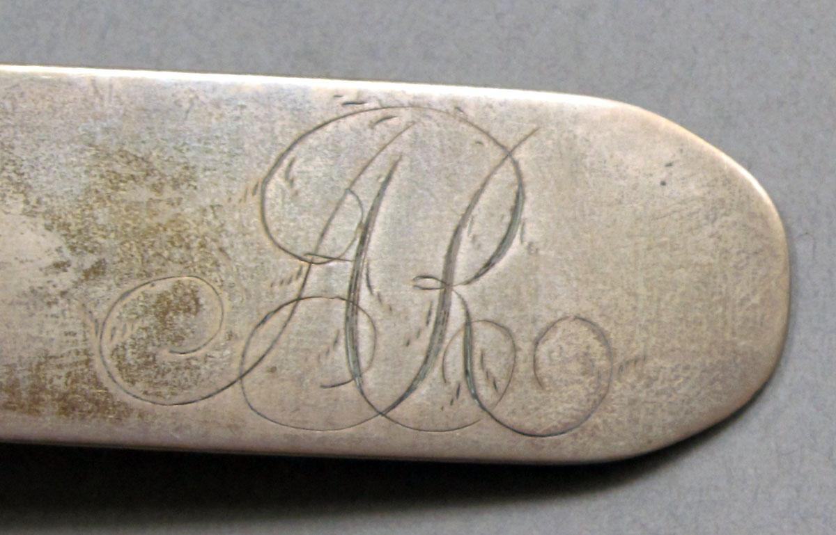 1962.0240.1227 Silver spoon engraving