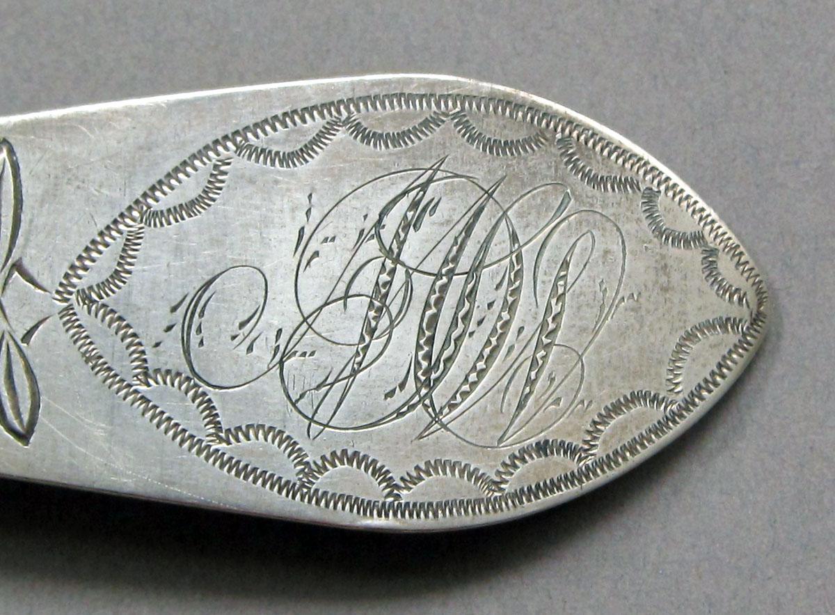 1962.0240.1229 Silver spoon engraving