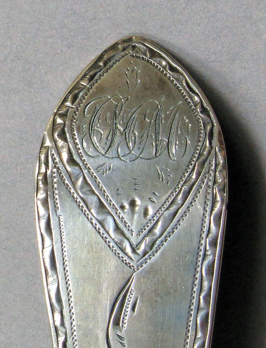 1962.0240.1231 Silver spoon engraving