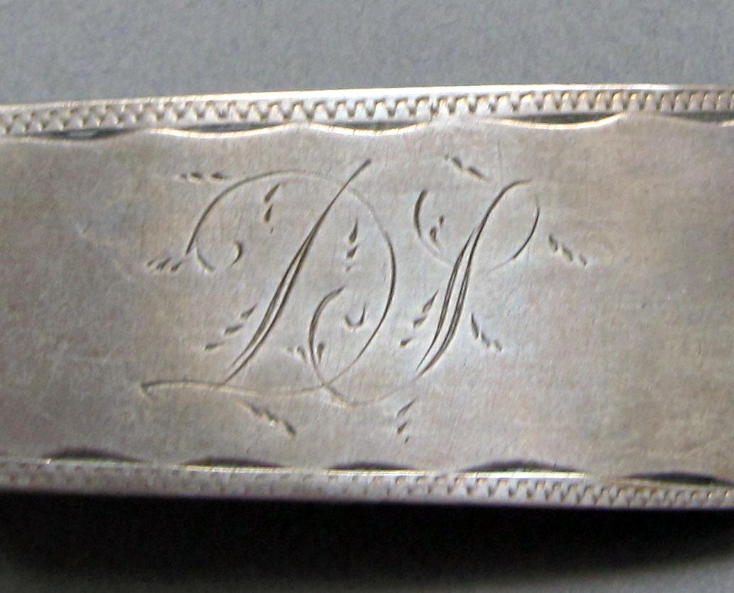 1962.0240.1243 Silver spoon engraving