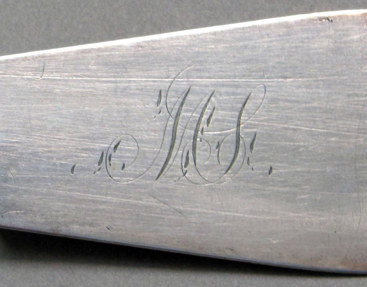 1962.0240.1281 Silver spoon engraving