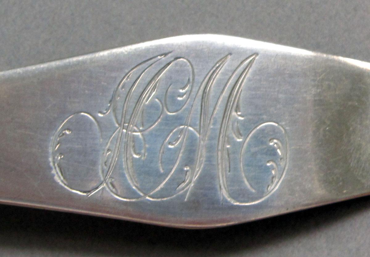 1962.0240.1306 Silver spoon engraving