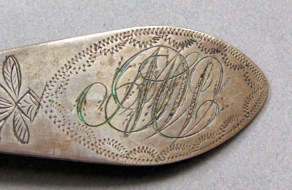 1962.0240.1483 Silver spoon engraving