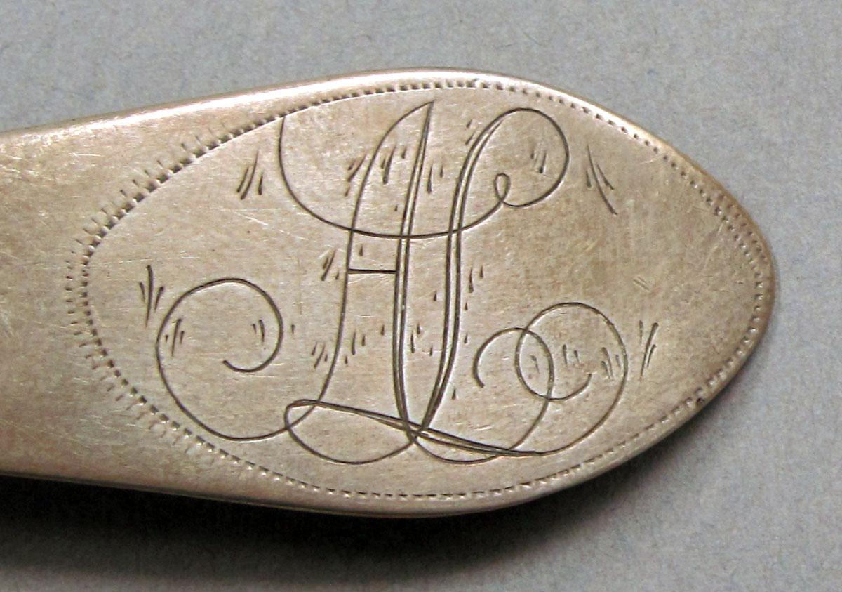 1962.0240.1510 Silver spoon engraving