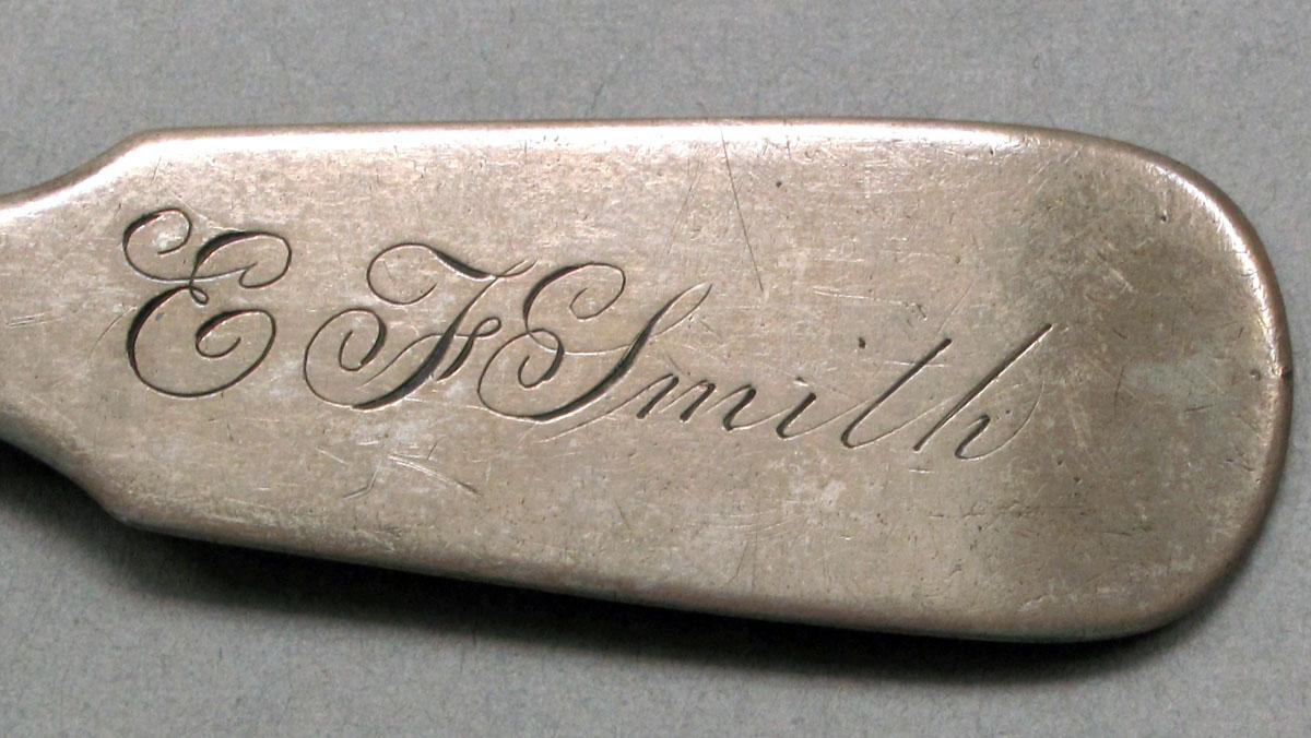 1962.0240.516 Silver fork engraving