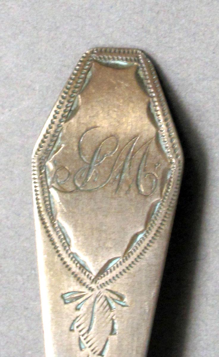 1962.0240.565 Silver spoon engraving