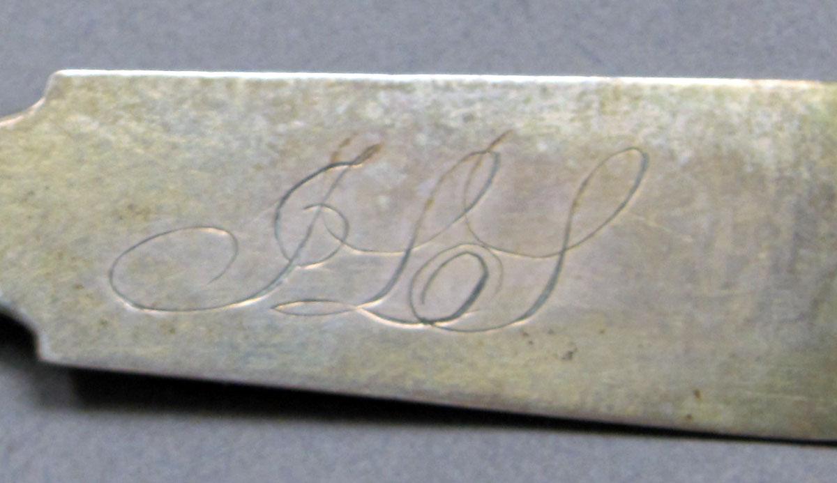 1962.0240.574 Silver spoon engraving