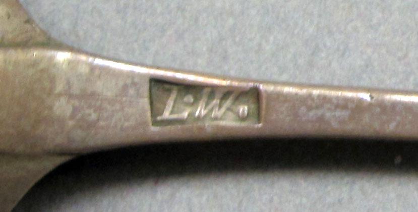1962.0240.595 Silver spoon mark