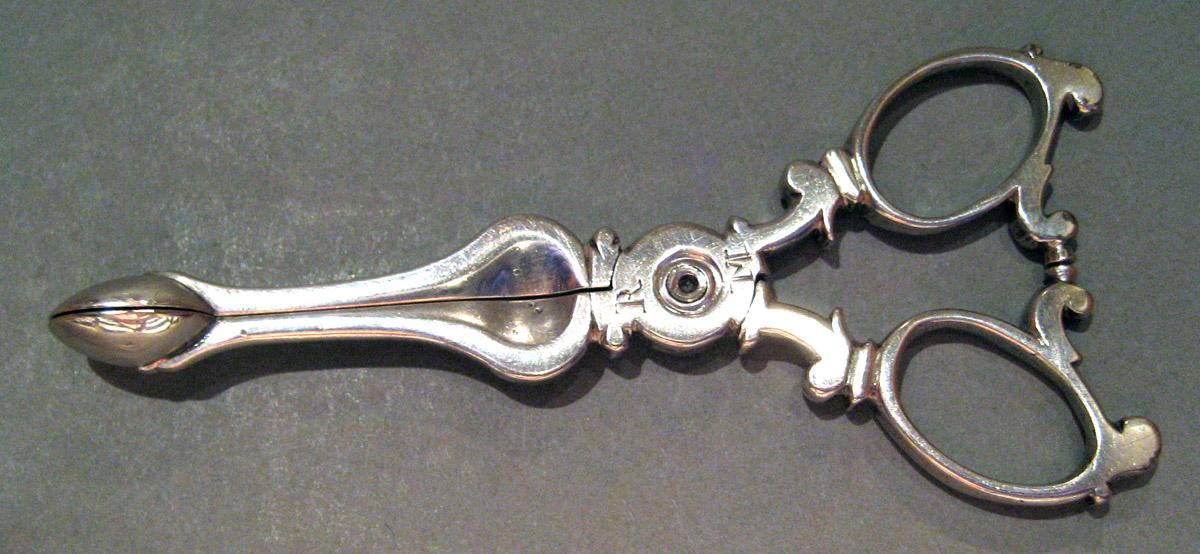 1955.0136.058 Silver Tongs side 1