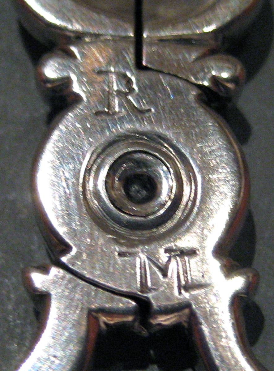 1955.0136.058 Silver Tongs engraving
