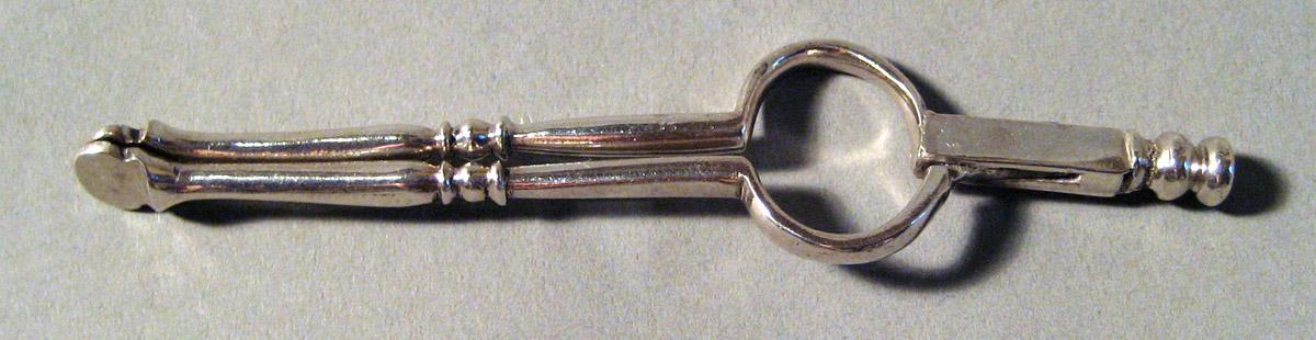 1955.0136.066 E Silver and Iron Tongs upper surface