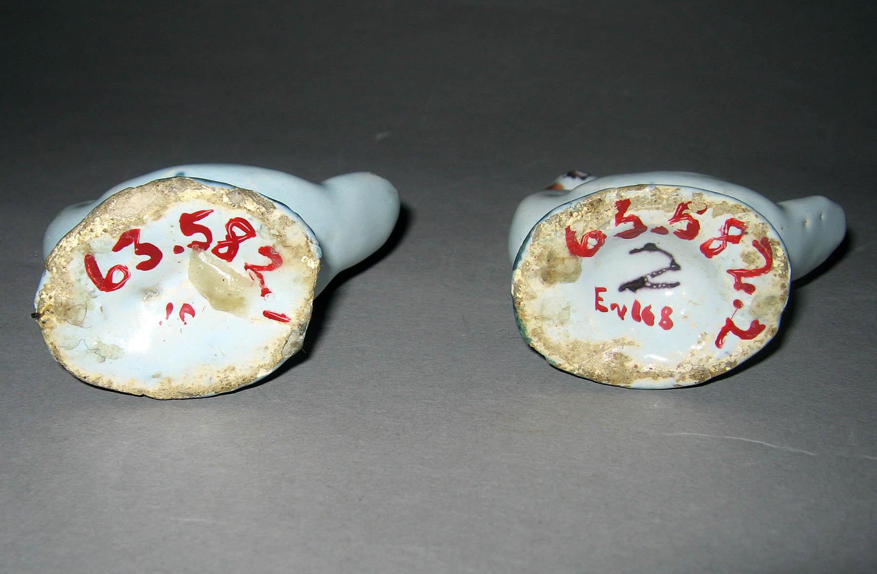 1963.0582.001, .002 Earthenware figures of swans (undersides)