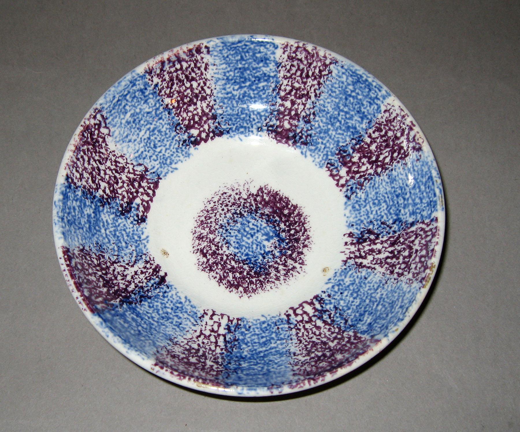 1963.0588 Blue and purple stripe spatterware saucer