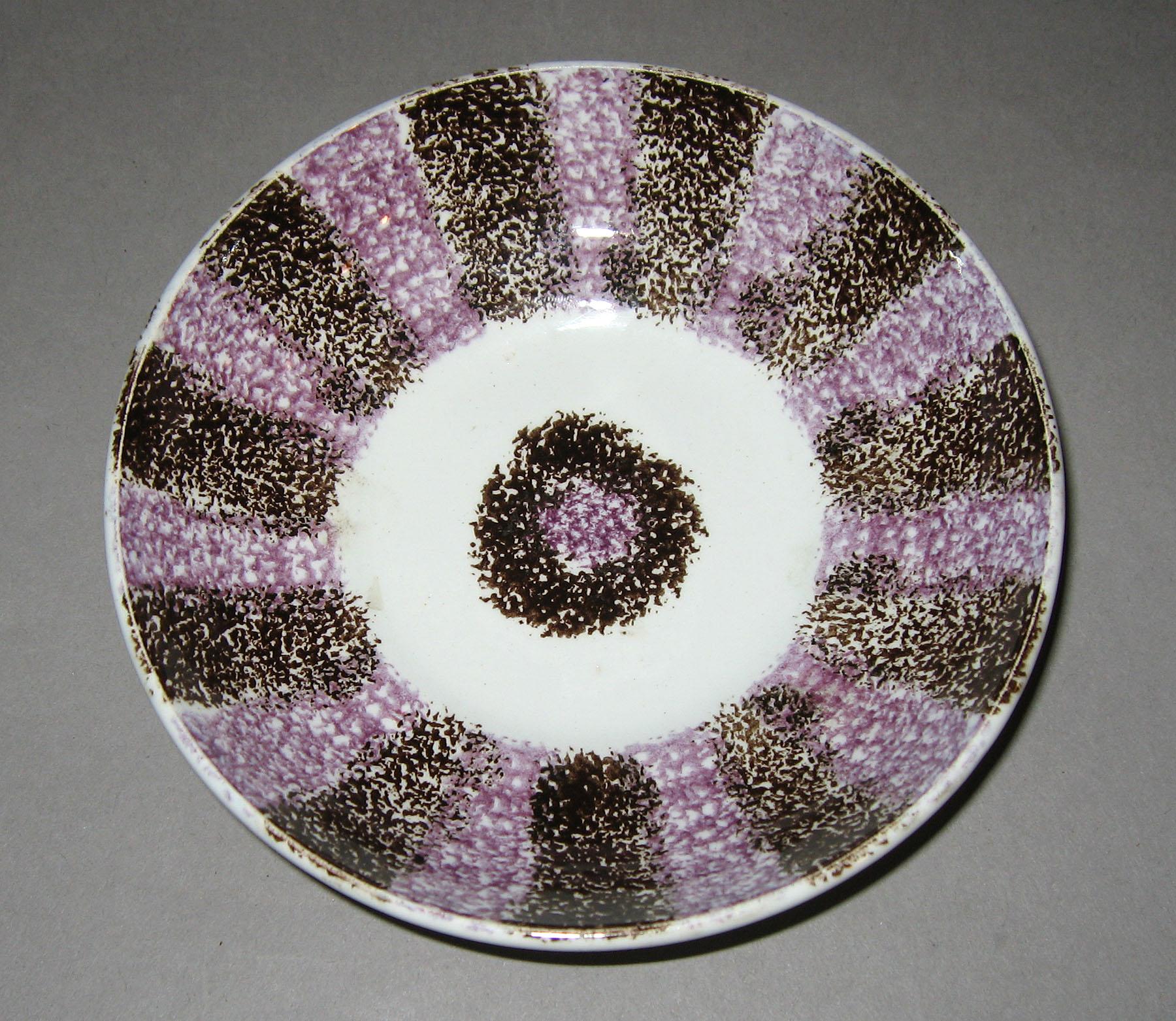 1963.0590 Purple and brown stripe spatterware saucer