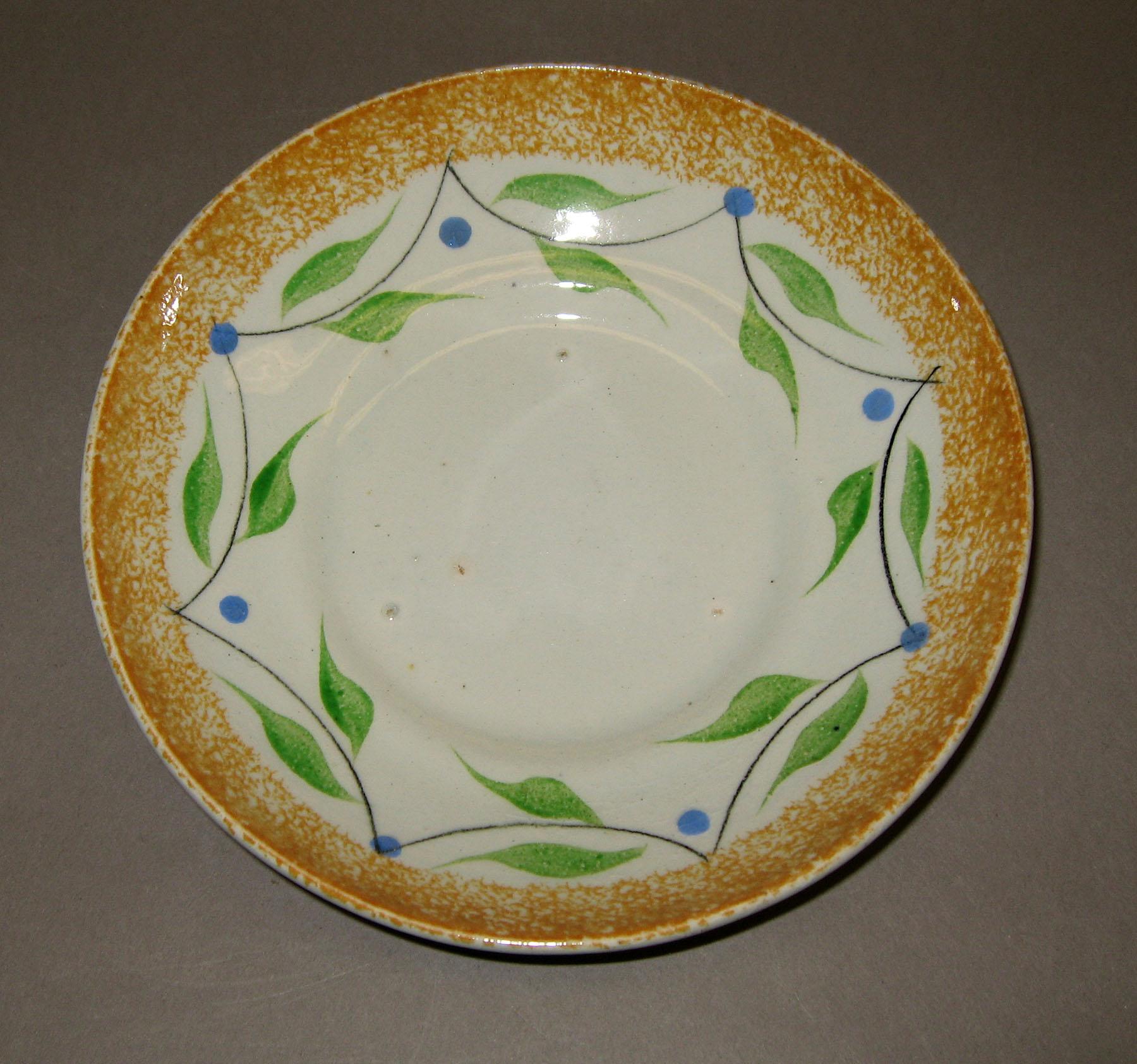 1963.0608 B Yellow spatterware saucer
