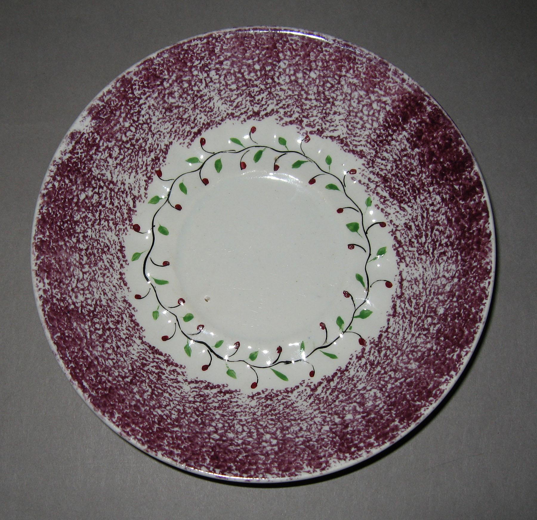 1963.0612.003 Holly berry spatterware saucer