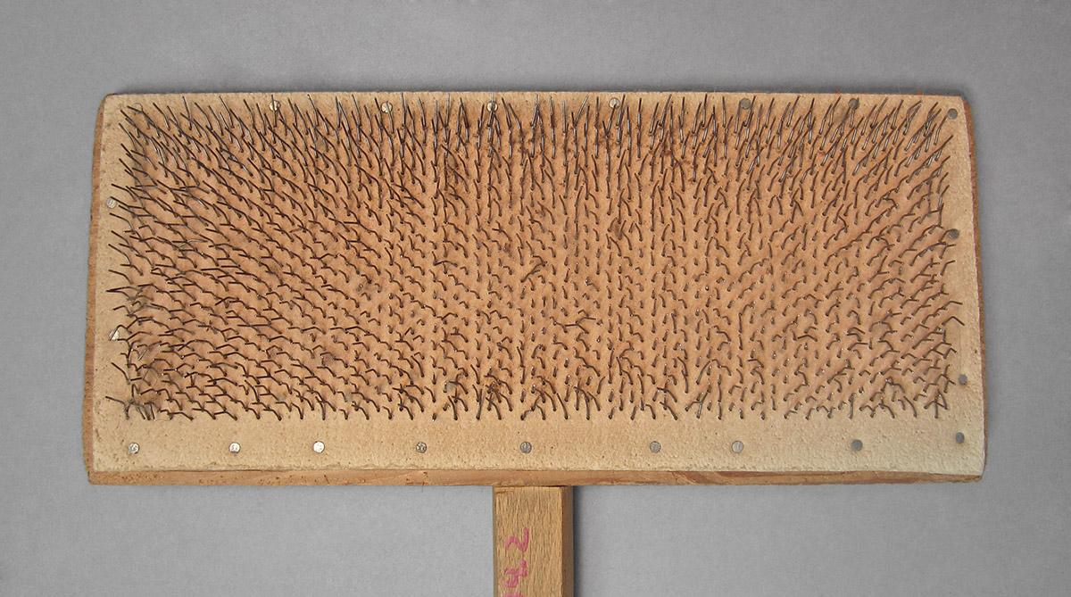 1963.1004.002, Wool card, side 1