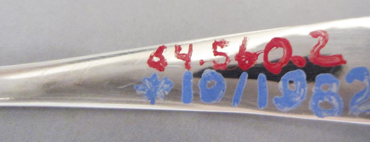 1964.0560.002 Spoon, inscription