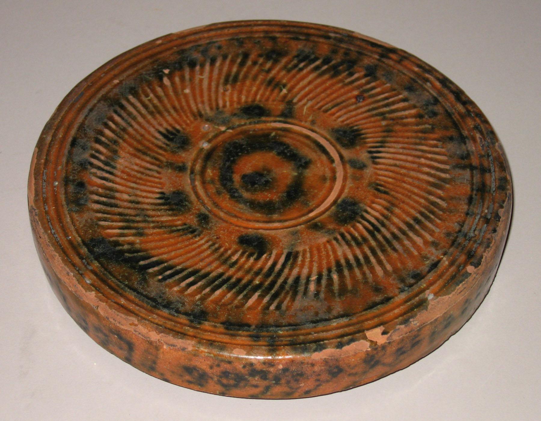 1955.0592 Redware trivet