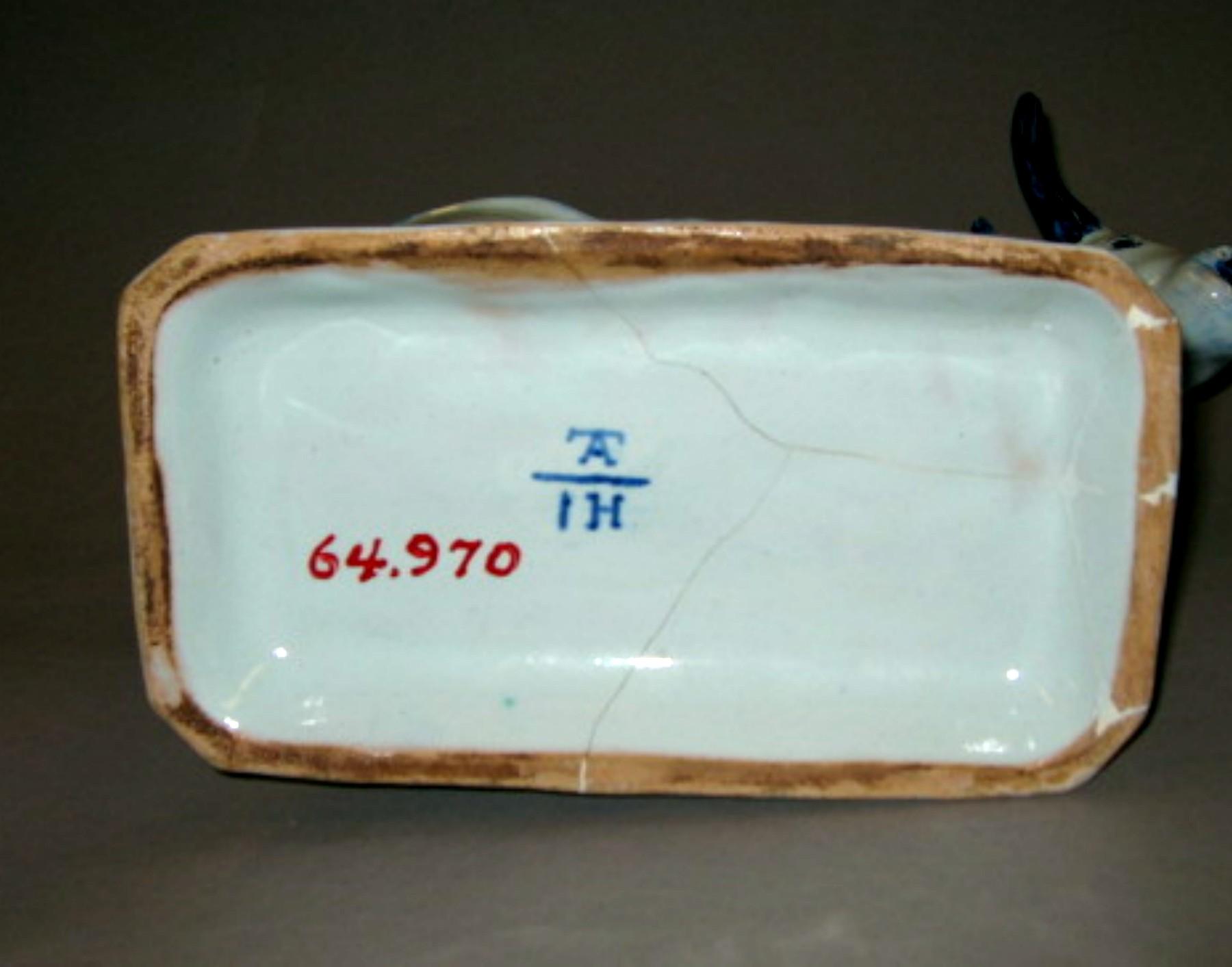 1964.0970 Tin-glazed earthenware figure (underside)