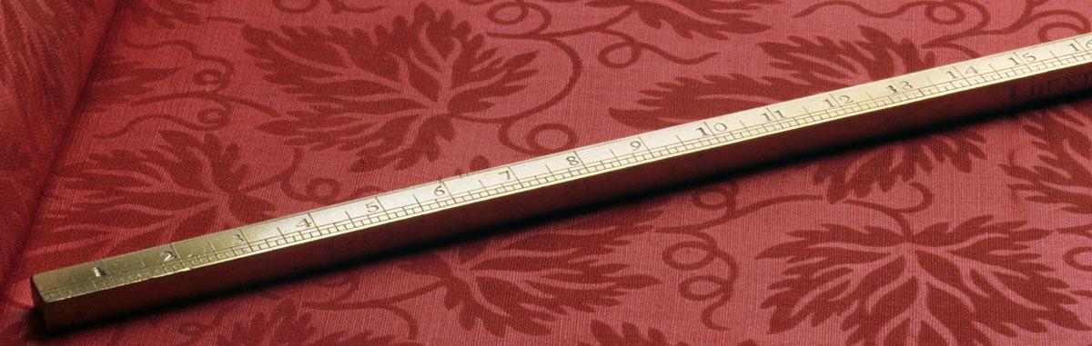 1964.1026 Yardstick, on sofa