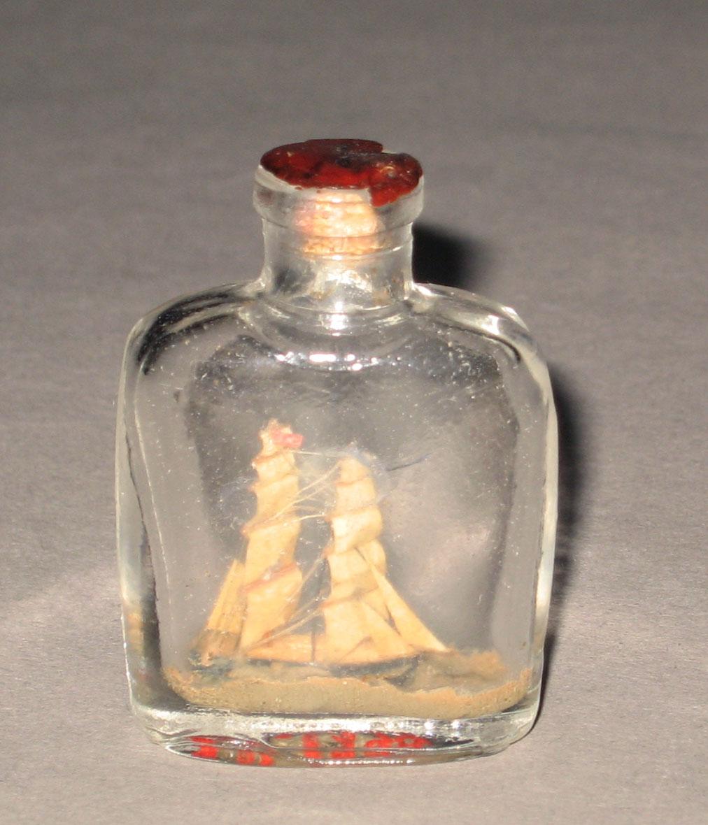 1964.1379 Miniature glass bottle with ship