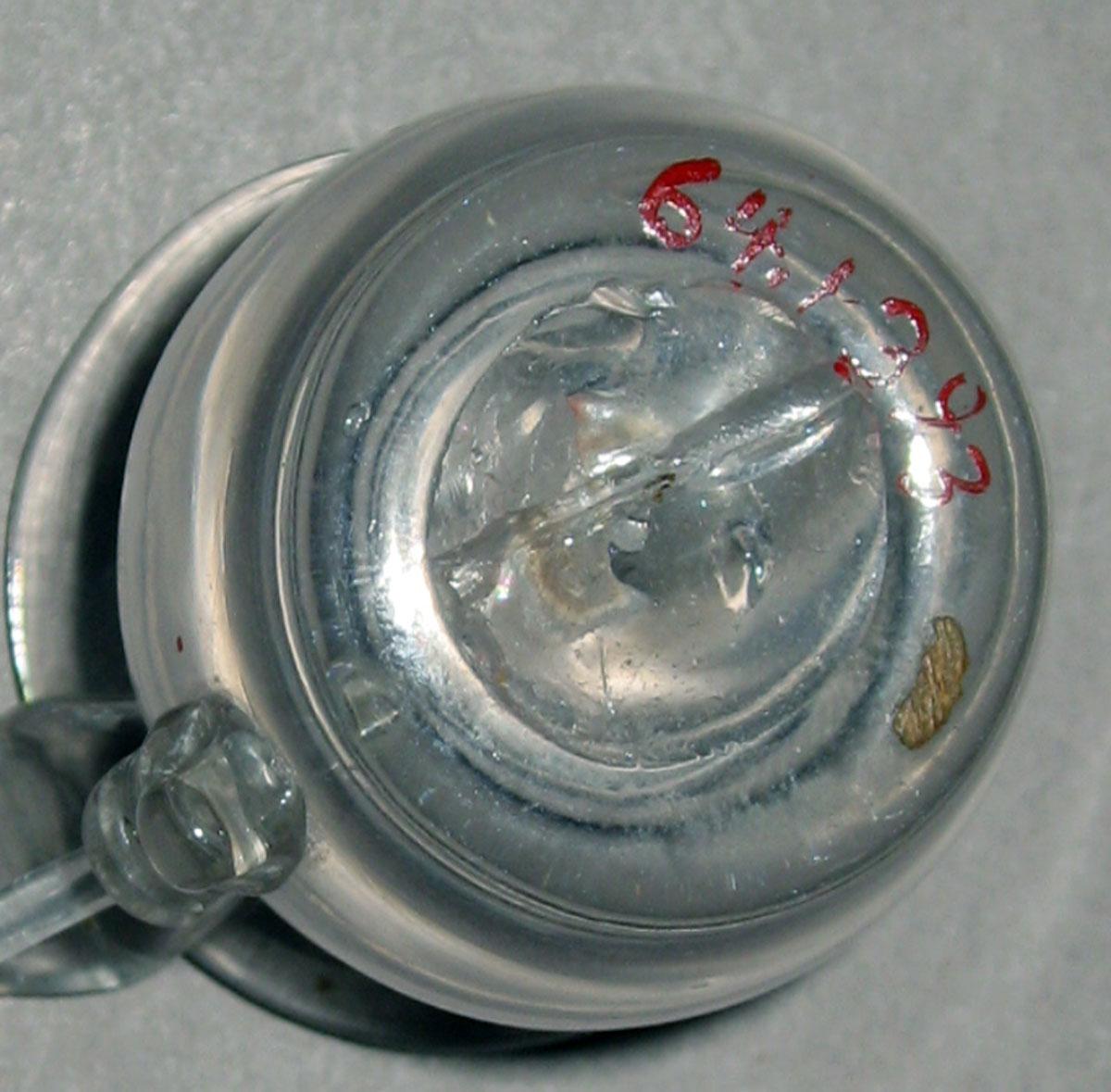 1964.1393 Colorless miniature jug (underside)
