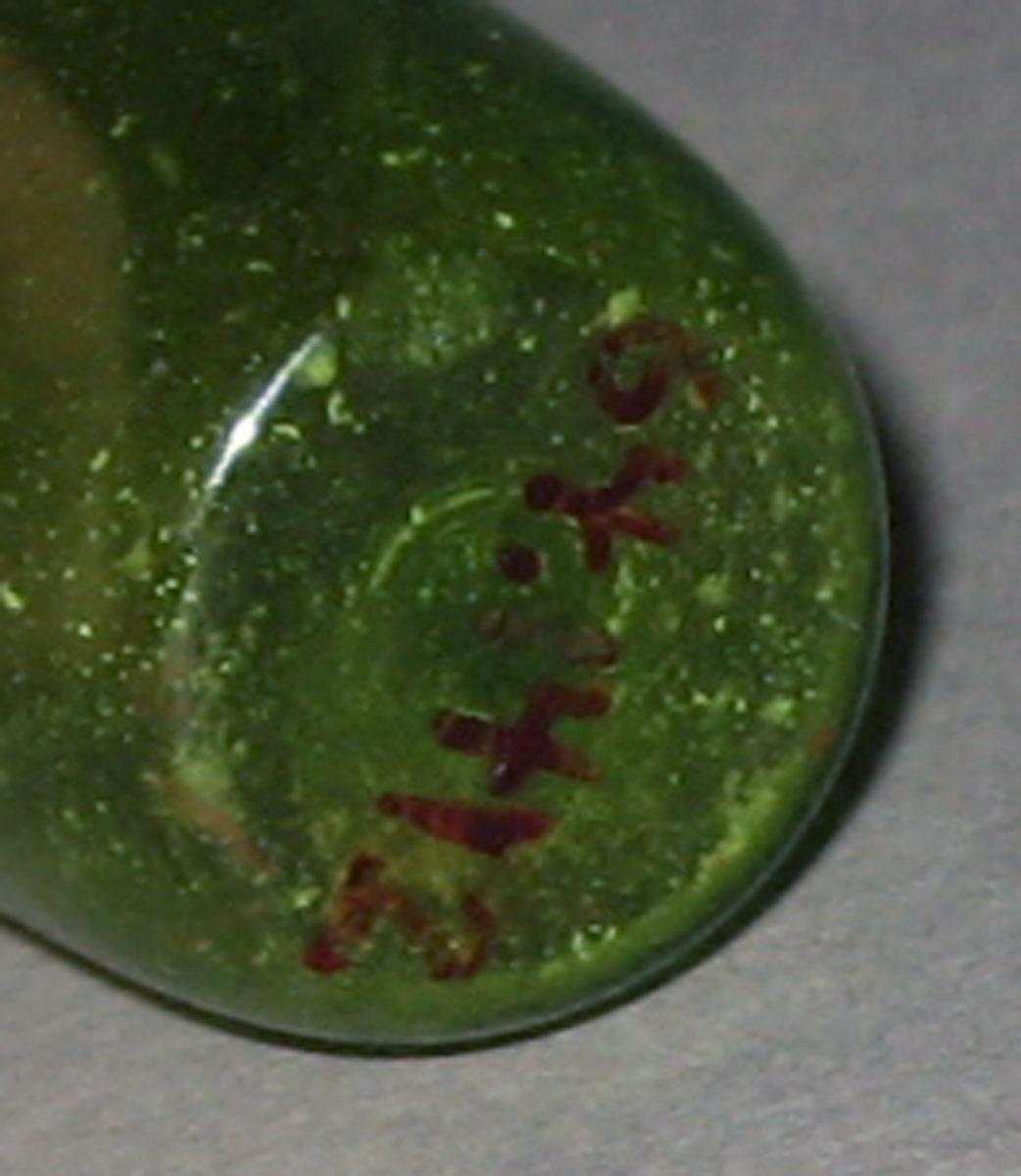 1964.1412 Miniature glass bottle (underside)