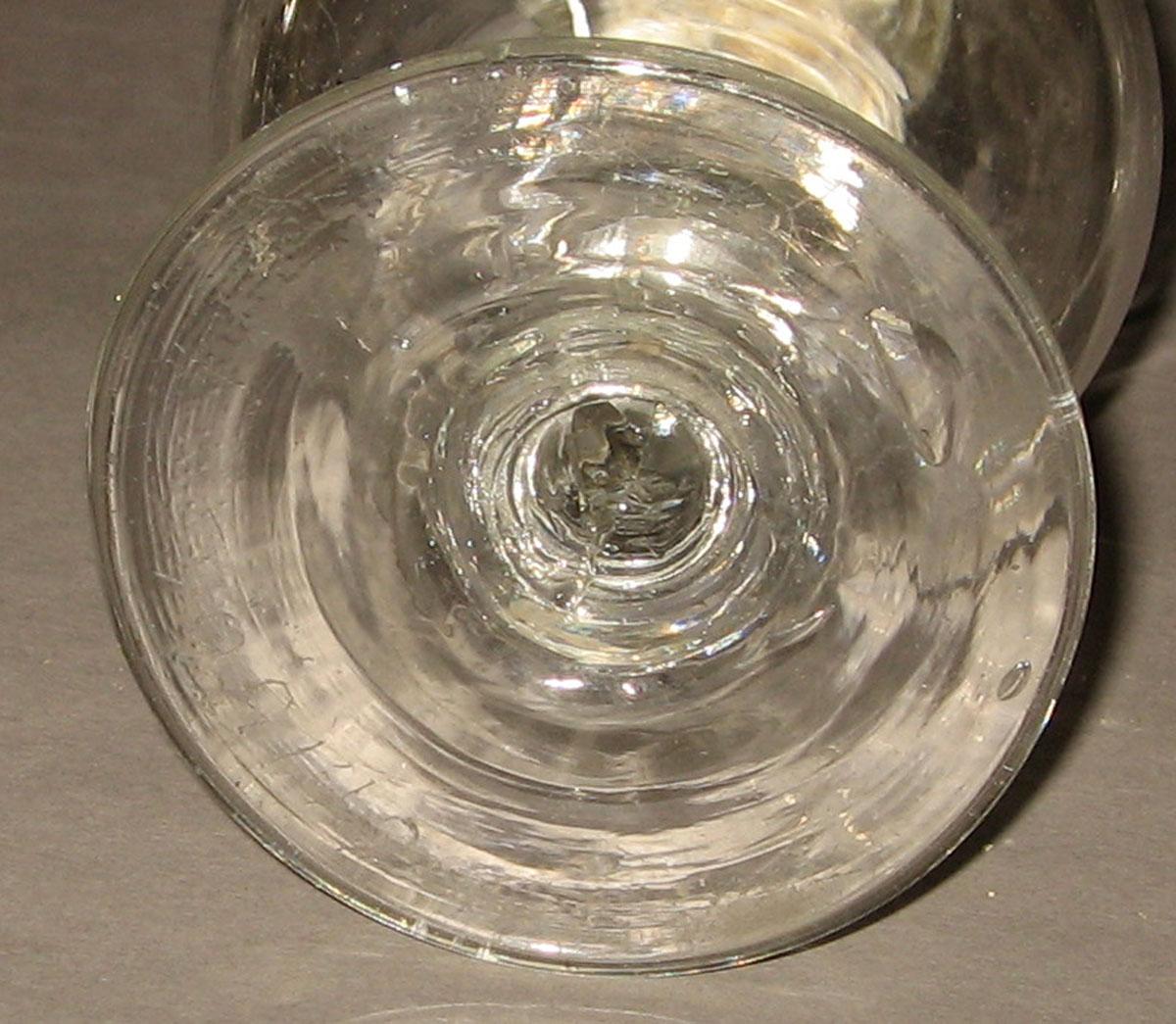 1964.1506 Colorless glass oil lamp (underside)