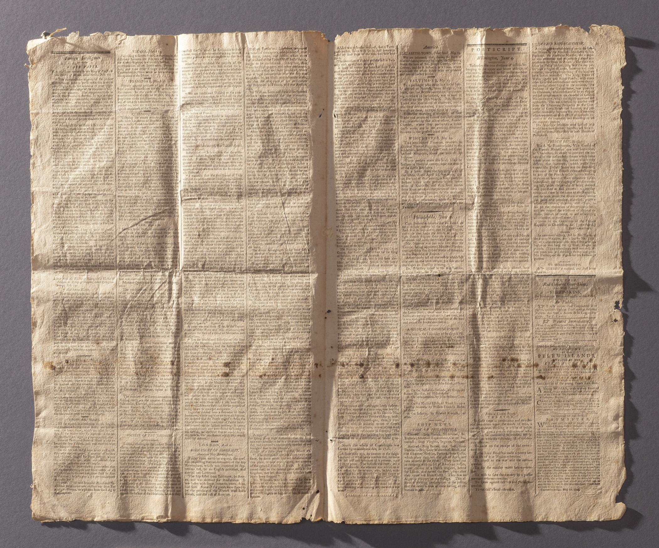 1964.1627 Newspaper, pages 2 and 3, view 2, raking light