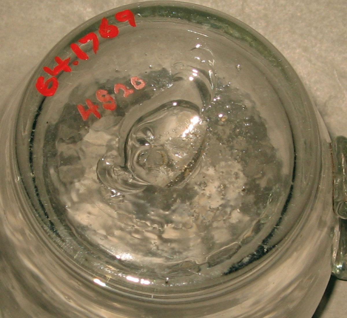 1964.1769 Colorless glass mug (underside)