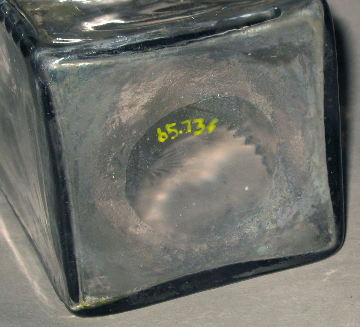 1965.0073 F Colorless glass case bottle (underside)