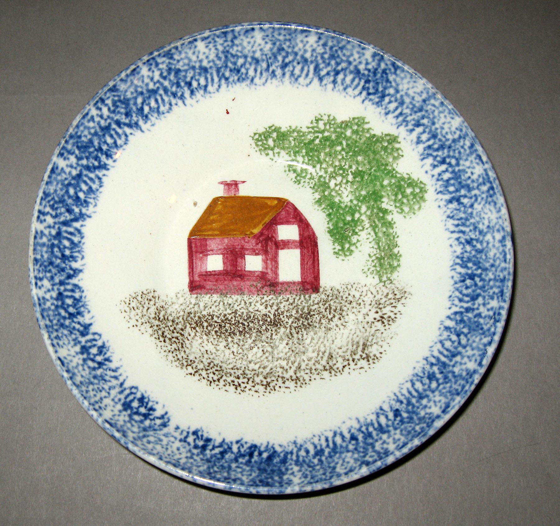 1965.0796.001 Blue spatterware school house pattern saucer