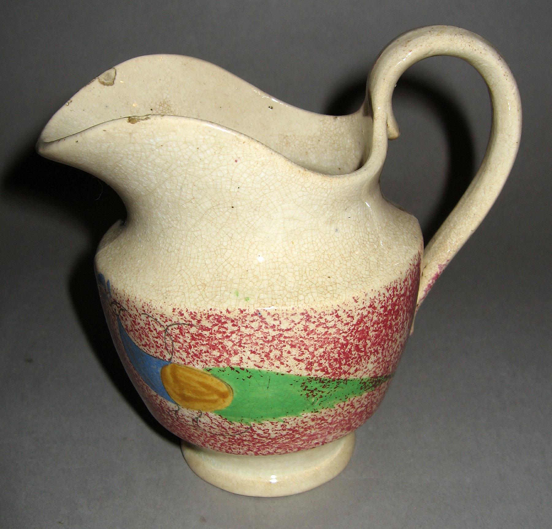 1965.0845 Pink spattterware peafowl jug