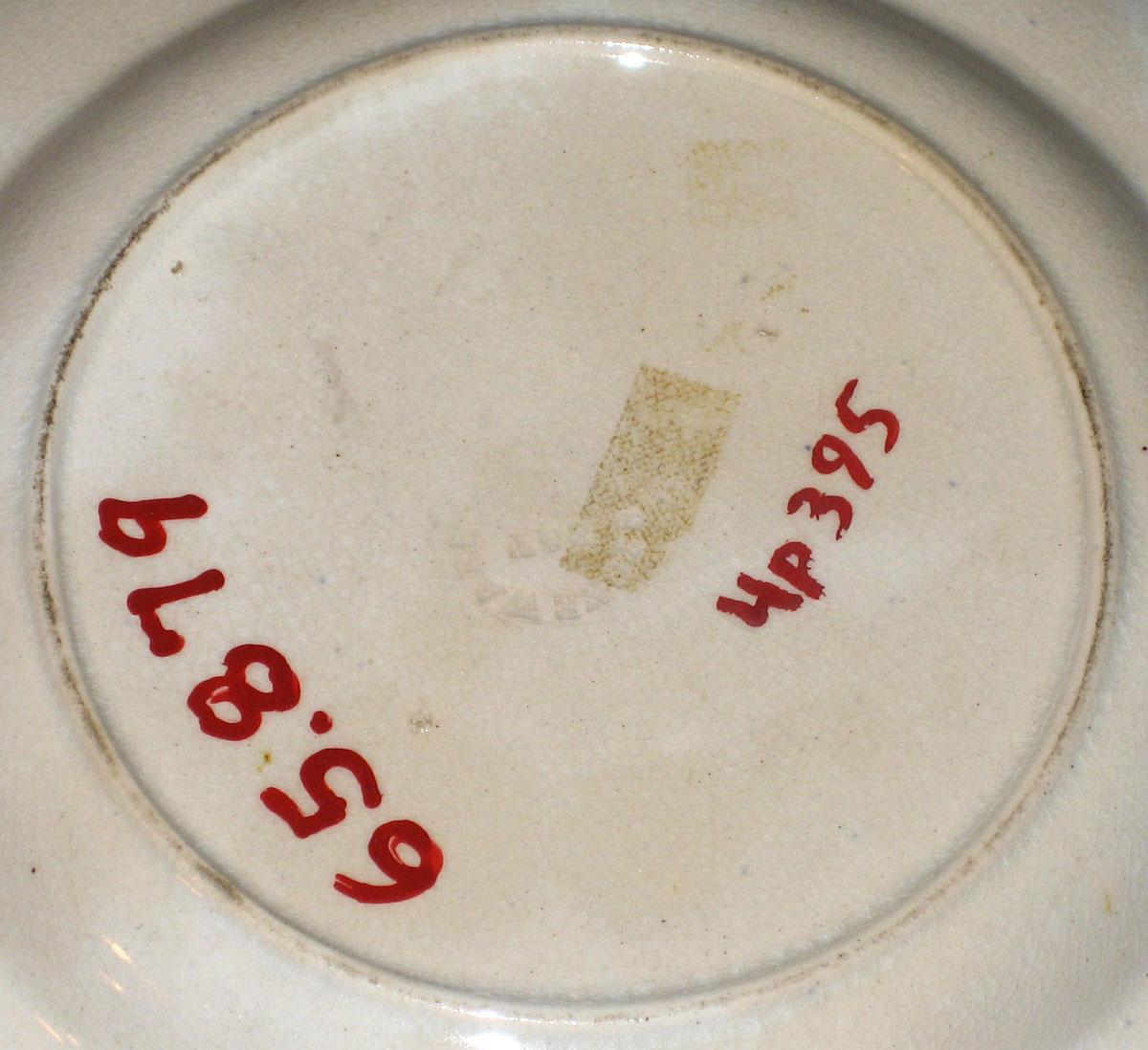 1965.0879 B & T mark--Pink spatter plate with peafowl pattern
