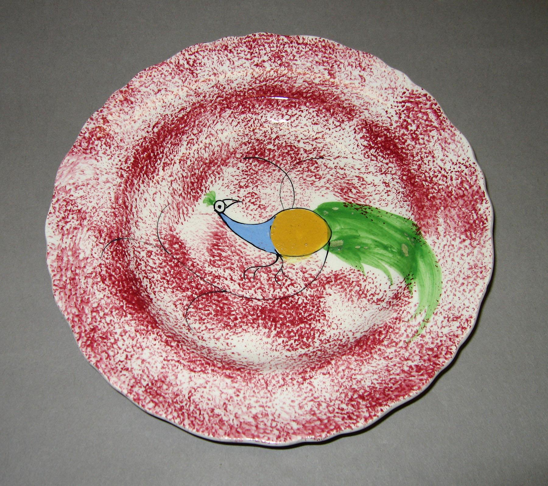 1965.0881.003 Pink spatter plate with peafowl pattern