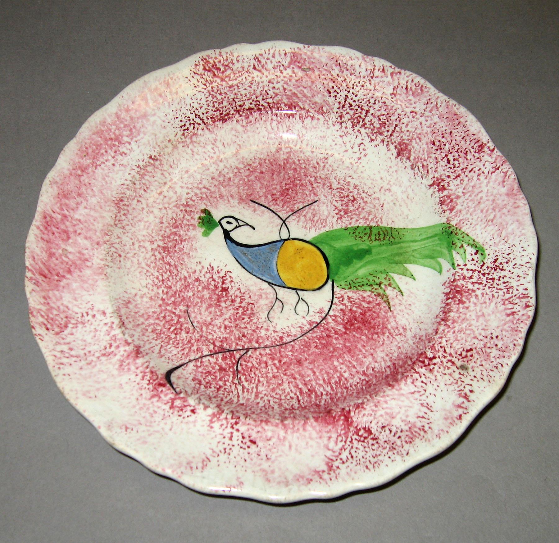 1965.0881.005 Pink spatter plate with peafowl pattern