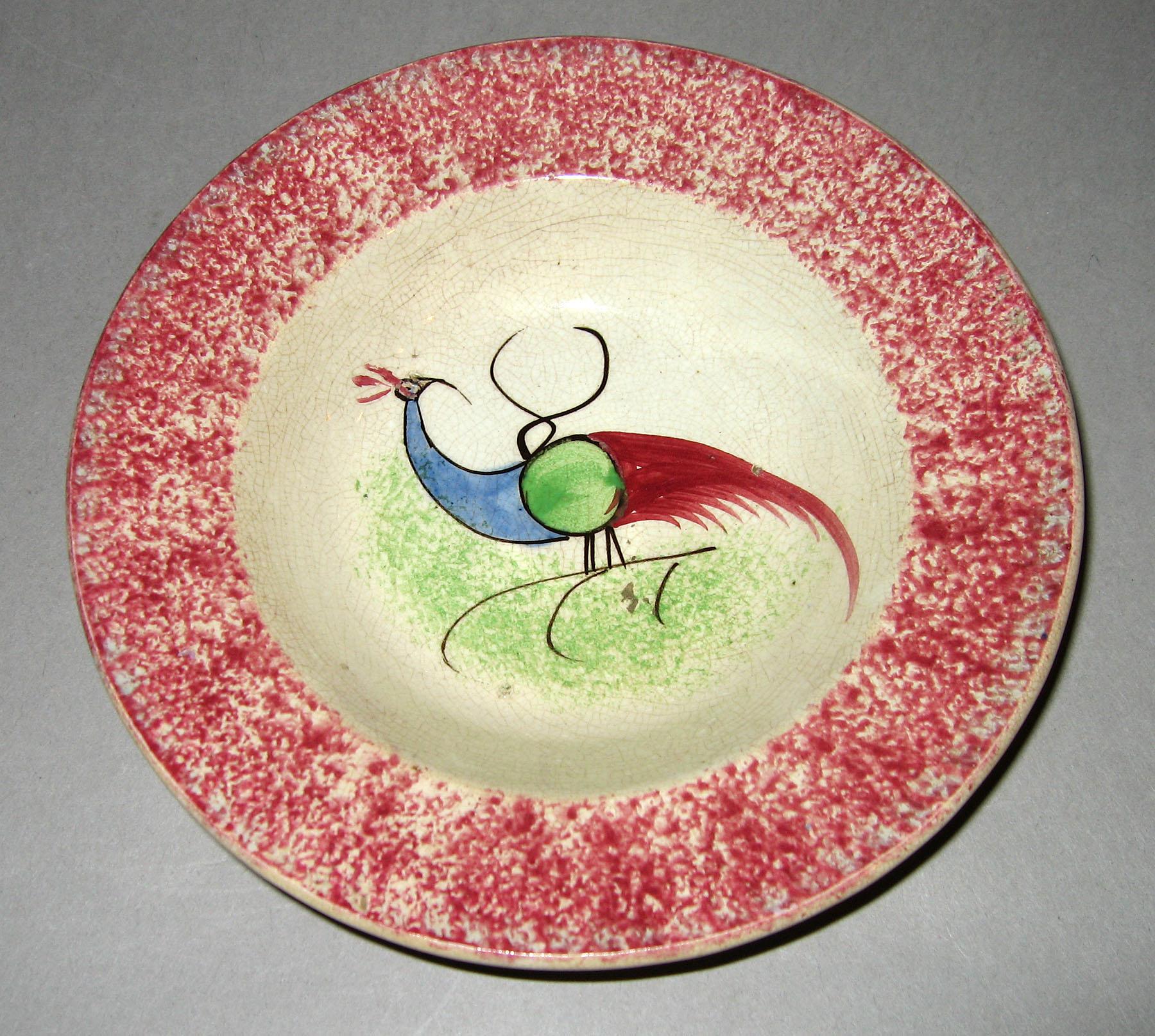 1965.0896.006 Pink spatterware peafowl saucer