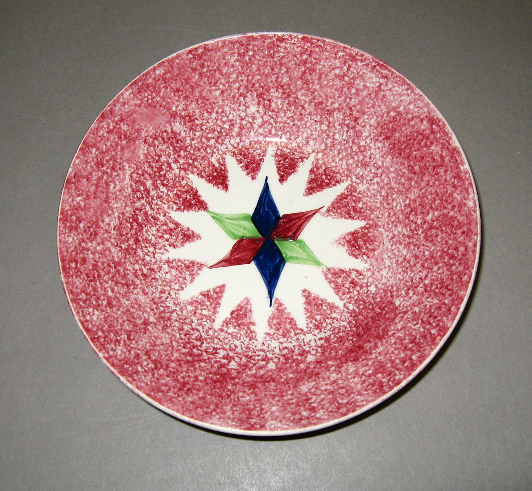 1965.0902.002 Star pattern red spatter saucer