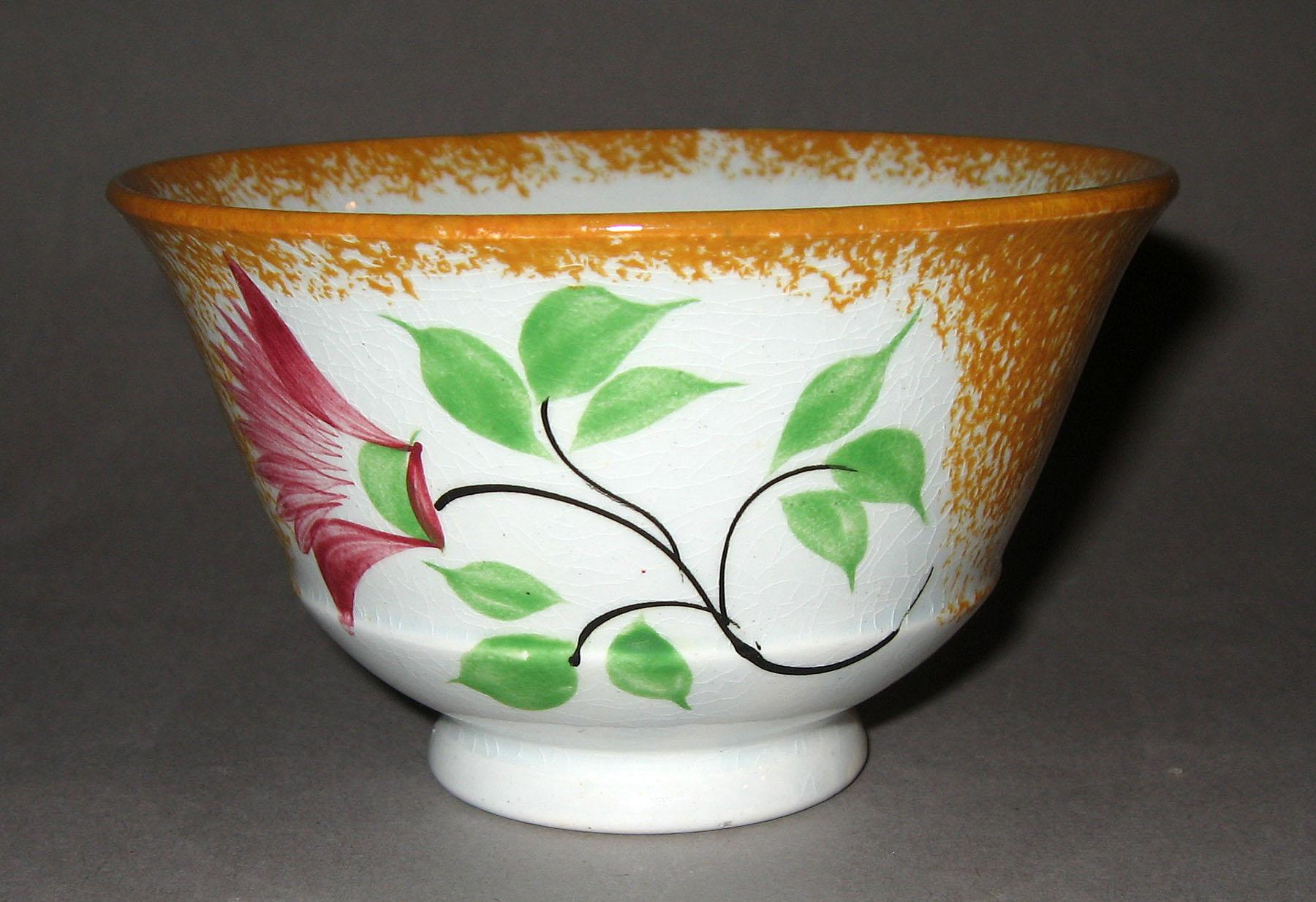 1965.0918.001 Yellow spatterware thistle pattern teabowl