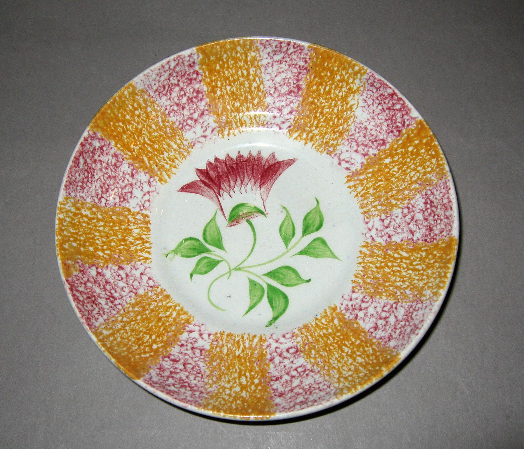 1965.0919.002 Yellow and pink spatterware thistle pattern saucer
