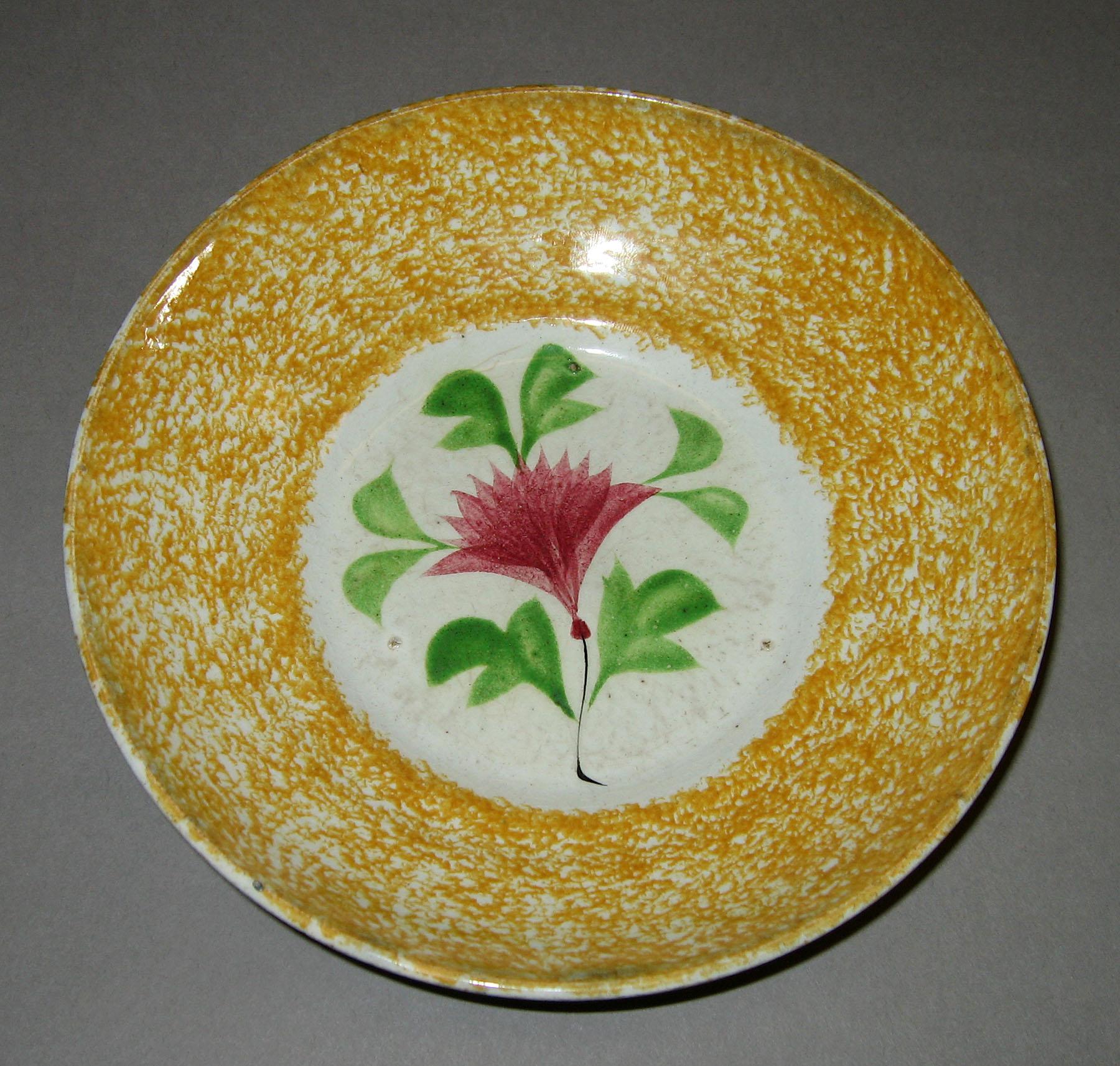 1965.0927.019 Cockscomb pattern yellow spatter saucer